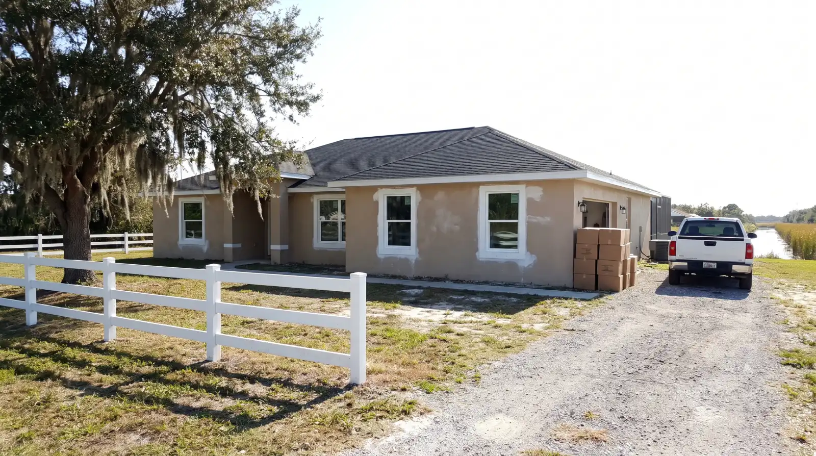 Impact windows on a ranch-style home with horse fencing in Davie, FL