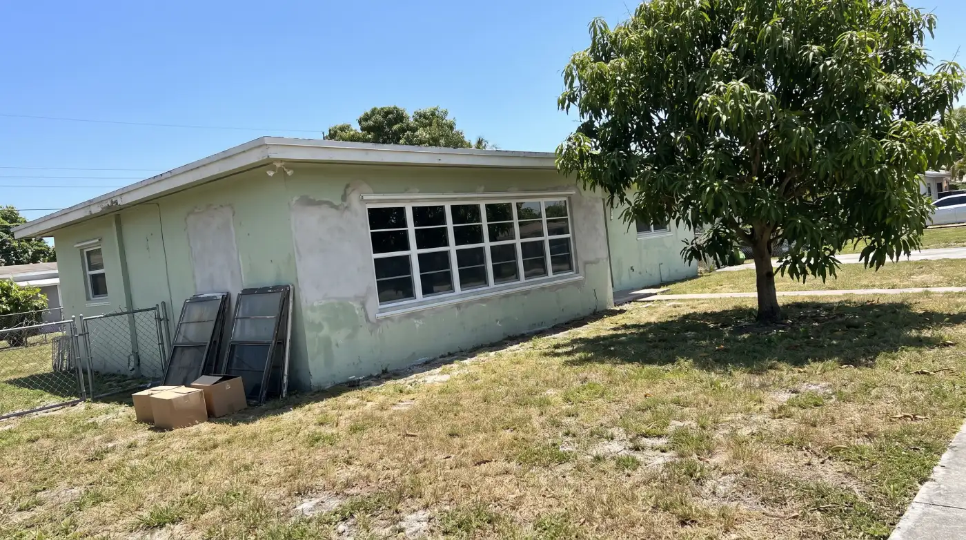 Impact windows on a 1960s concrete-block home in Miami Gardens, FL