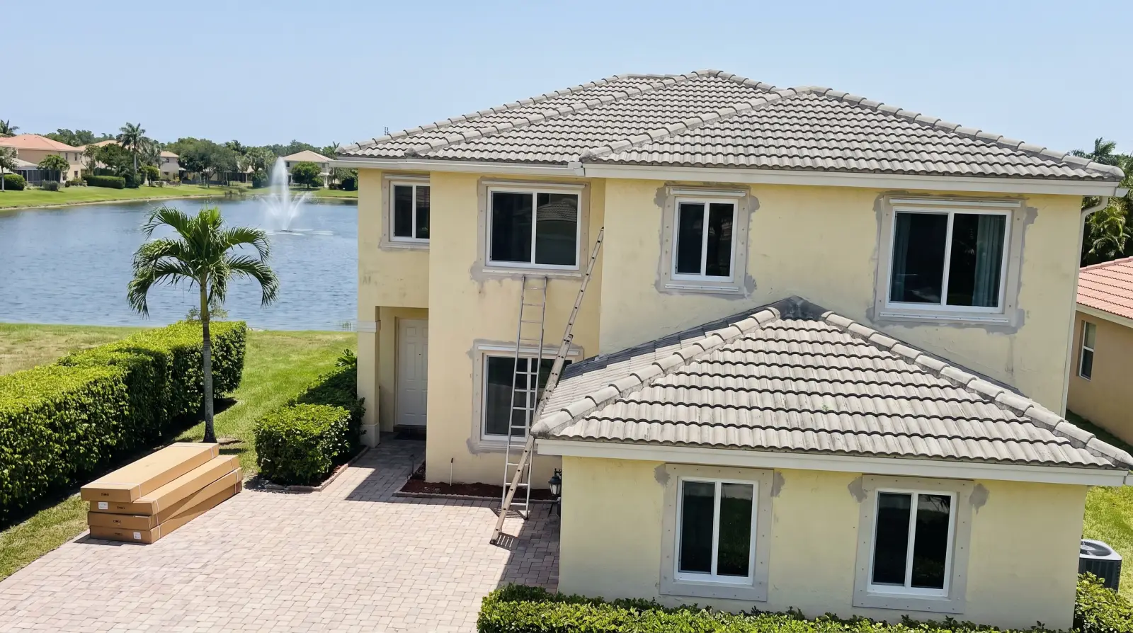 Impact windows on a two-story stucco home in a Miramar, FL lake community