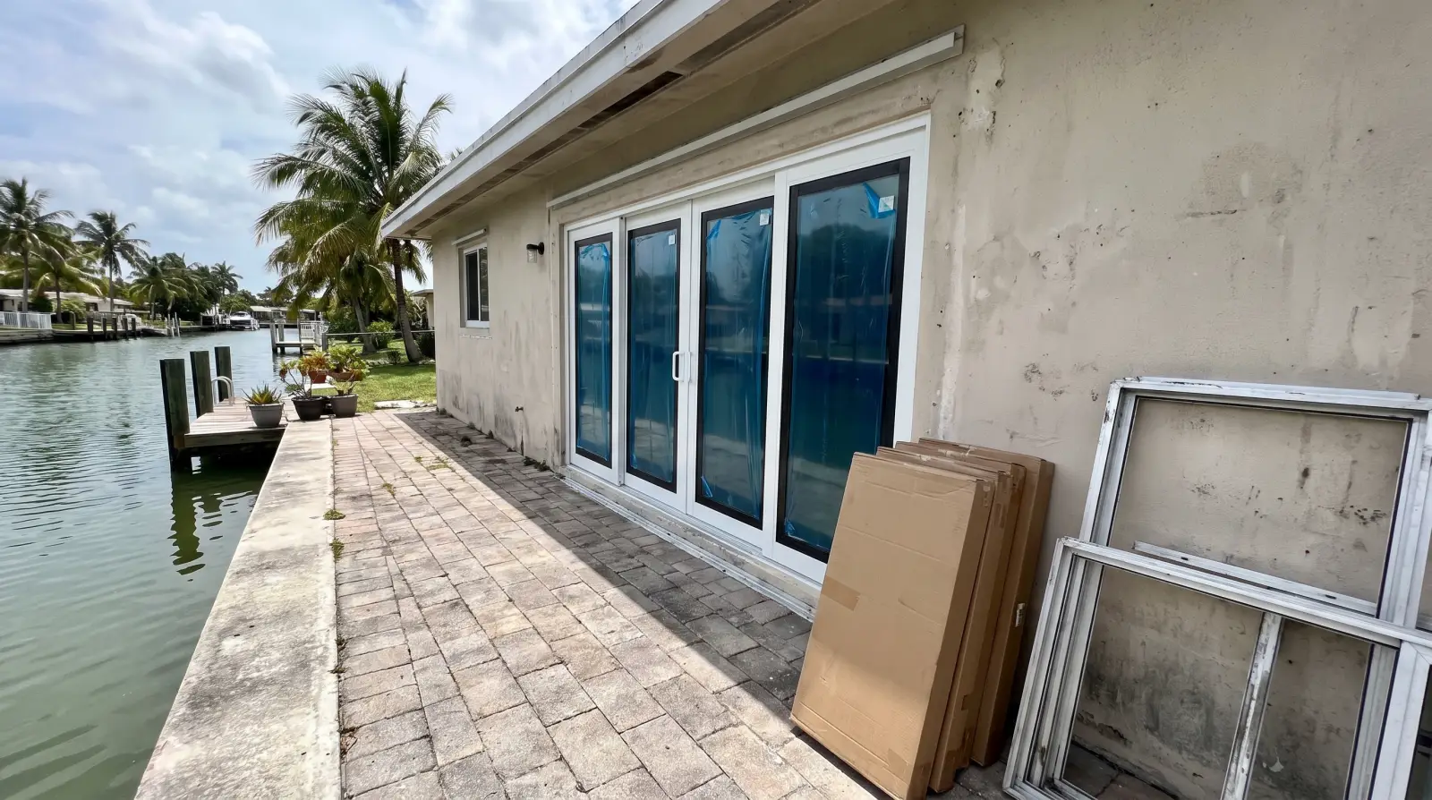 Impact sliding glass door opening onto a canal-side patio in Fort Lauderdale, FL