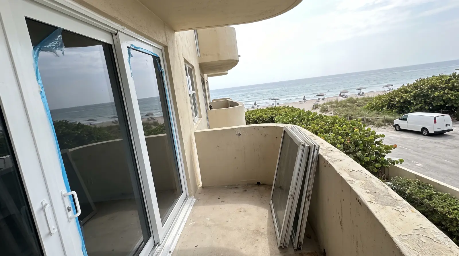 Impact sliding glass door on an oceanfront balcony in Lauderdale-by-the-Sea, FL