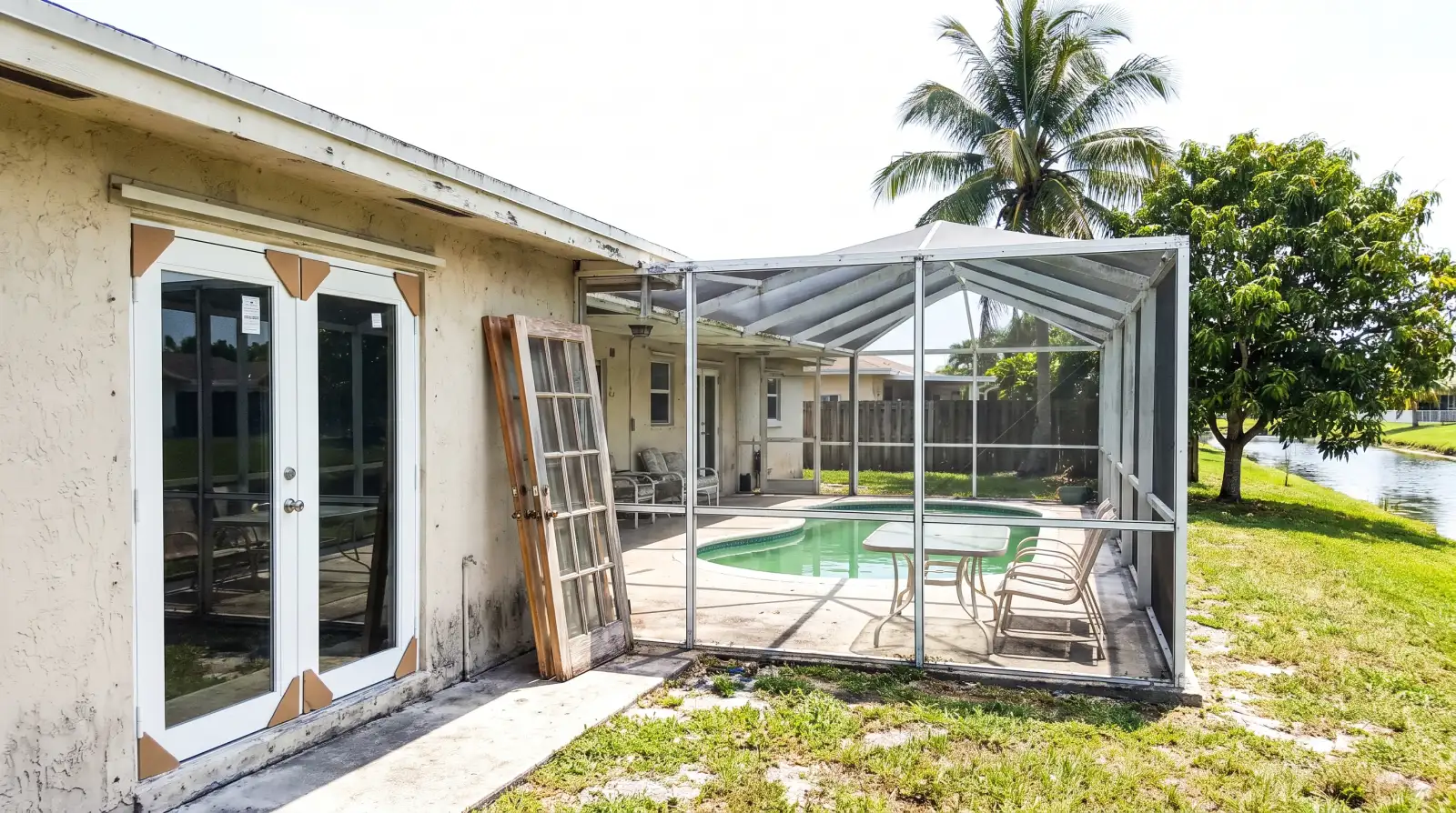 Impact French doors opening to a pool deck in Margate, FL