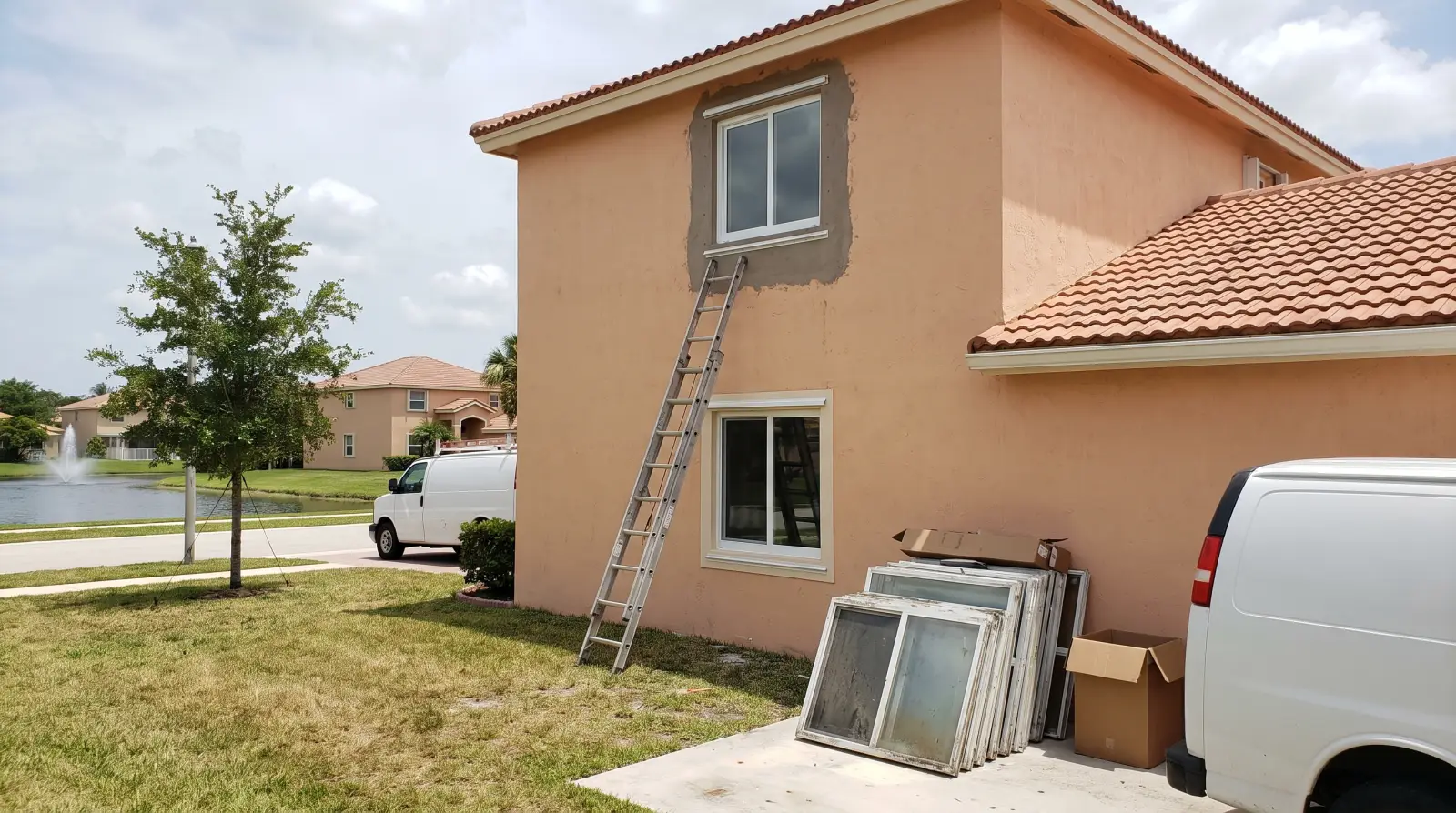 Impact windows being installed on a 1990s home in a Pembroke Pines, FL subdivision